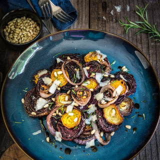 Roasted beets and charred onion salad - sweet and smoky, earthy and flavorful, with rosemary, pine nuts, Pecorino cheese, and a drizzle of truffle oil - this warm salad is nothing short of spectacular! | www.viktoriastable.com