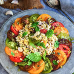 Garlic tuna tomato salad - loaded with aromatic basil and garlic, tangy capers and sharp mustard flavors, this is a super delicious summer salad that works great for a light dinner. | www.viktoriastable.com