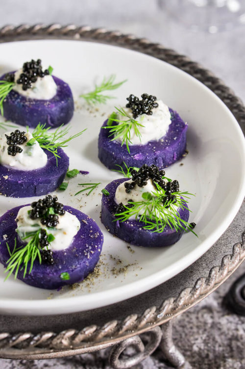 Purple potato bites with horseradish creme fraiche and caviar - bold colors and big flavors packed into a small, delicious morsel - the perfect starter for your holiday dinner or a cocktail party. | www.viktoriastable.com