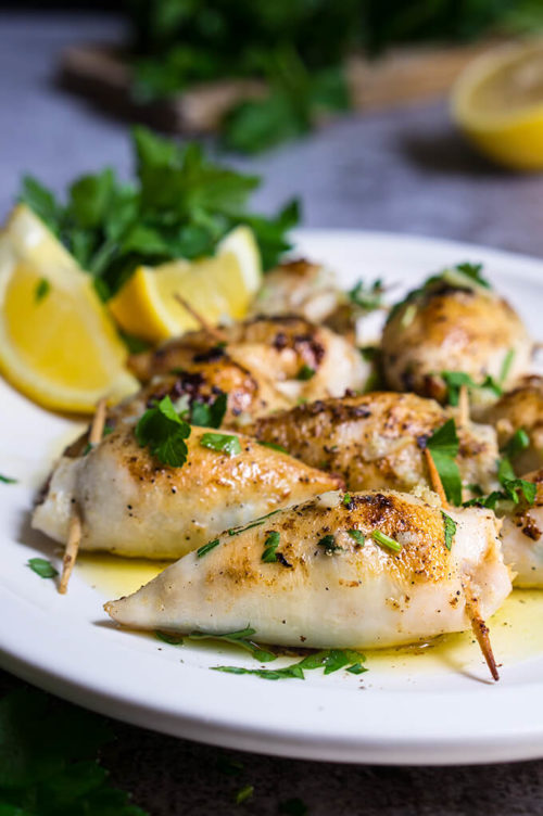 Stuffed calamari in lemon butter sauce - these delicious calamari bites are stuffed with creamy tuna filling, then cooked in a luscious tangy lemon butter sauce, with capers, garlic and lots of fresh parsley. | www.viktoriastable.com