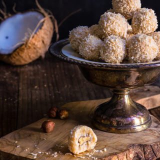 White chocolate coconut truffles - creamy, coconut filling, melt-in-your-mouth white chocolate, and a toasted hazelnut inside make these homemade Raffaello truffles an irresistible treat. | www.viktoriastable.com