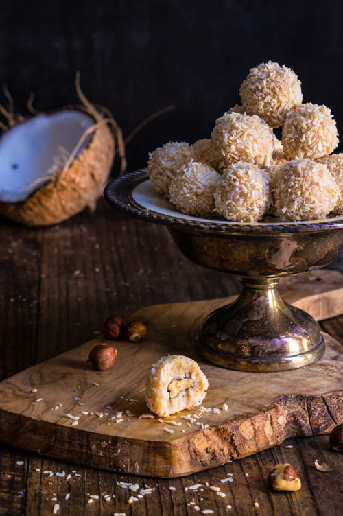 White chocolate coconut truffles - creamy, coconut filling, melt-in-your-mouth white chocolate, and a toasted hazelnut inside make these homemade Raffaello truffles an irresistible treat. | www.viktoriastable.com