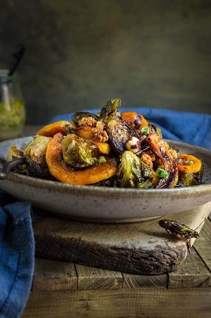 Roasted brussels sprouts and squash salad with horseradish dressing - this warm salad combines all the favorite flavors of fall - the sweetness of roasted veggies and dry fruit, with crunchy nuts, and a pungent horseradish dressing that ties them all in. | www.viktoriastable.com