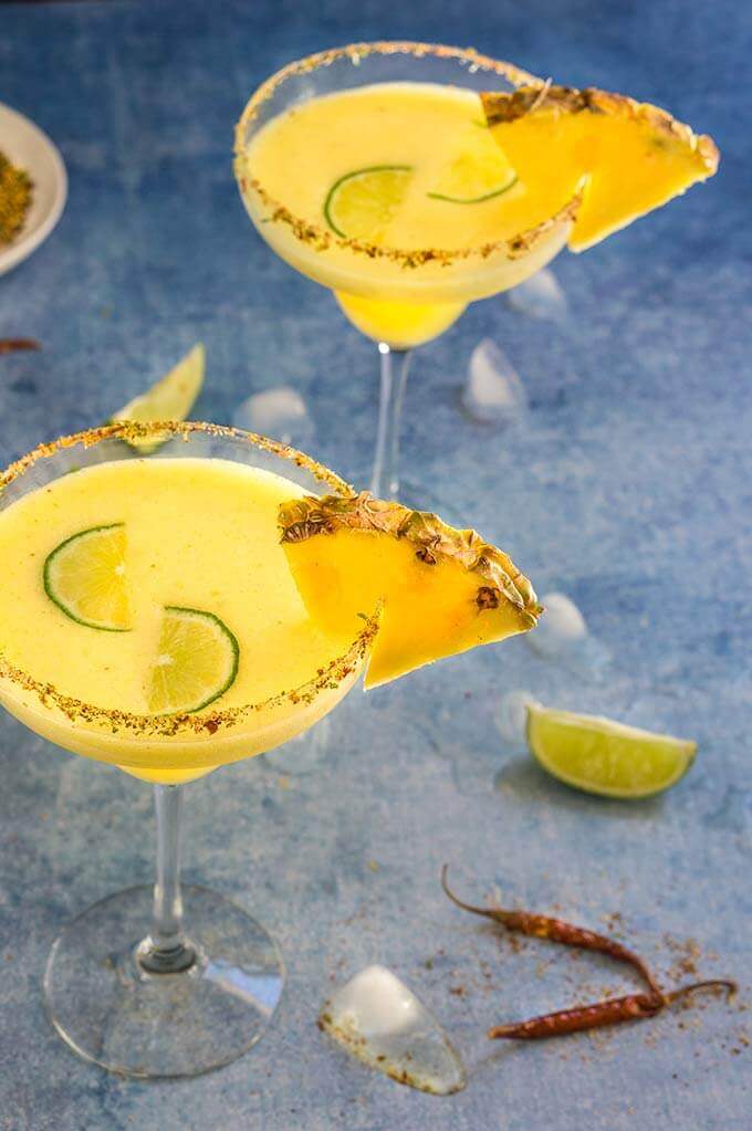 Spicy pineapple margarita - icy-cold, with a spicy kick, fruity and refreshing, served with fragrant chili lime salt, this drink will give you just the right amount of heat and freshness. | www.viktoriastable.com