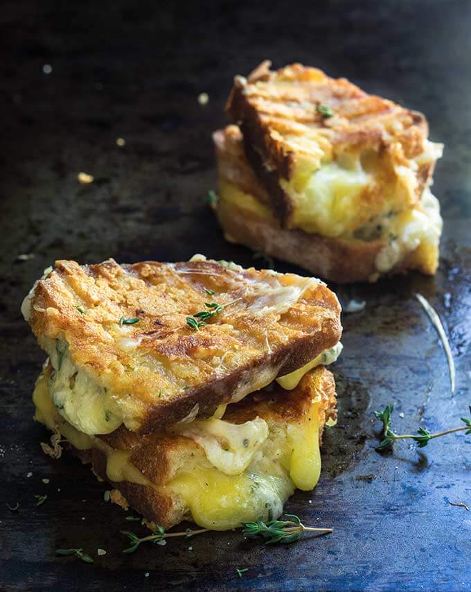 Garlic and herb loaded grilled cheese sandwich - four different cheeses, flavored with garlic and thyme, come into play, to create the ultimate, grilled cheese lover's dream sandwich. | www.viktoriastable.com