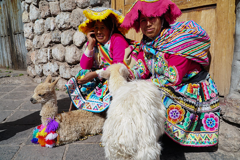 Quechua ladies posing with their llamas - Cusco