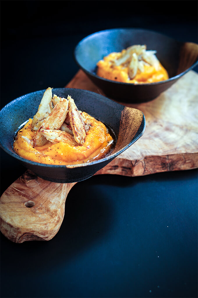 Tender crab meat is sauteed in garlic butter, and served over roasted squash and coconut puree for a luxurious appetizer. | www.viktoriastable.com