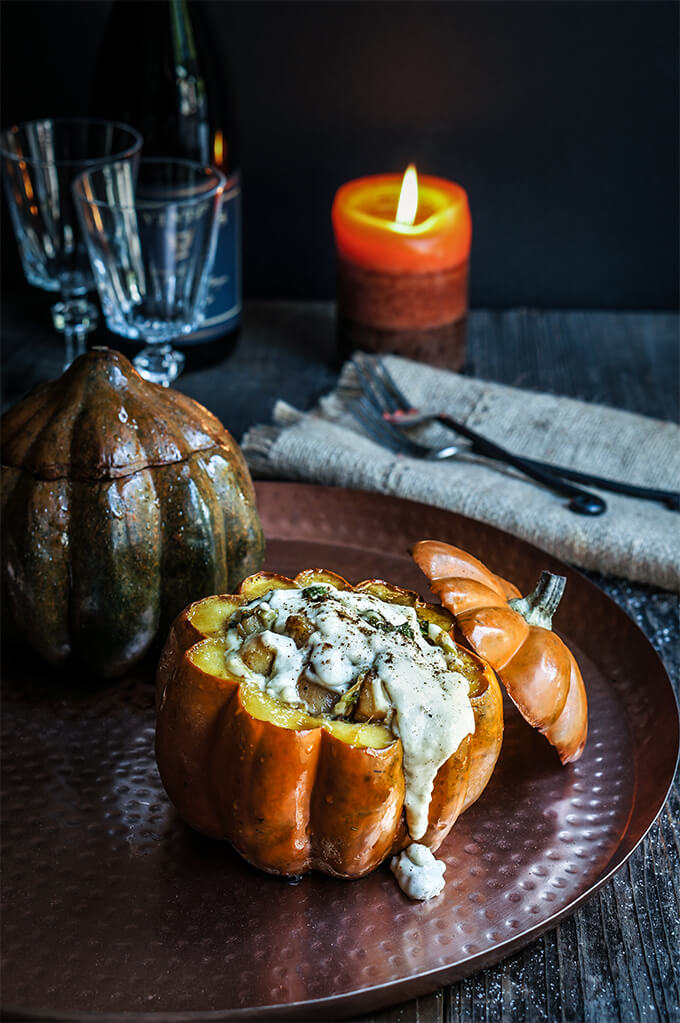  Stuffed pumpkin with bacon, leeks, and scallops, smothered in cheesy bechamel sauce, and a touch of cinnamon! Try this festive Thanksgiving recipe that's not only a feast for your eyes but it's super delicious too! | www.viktoriastable.com