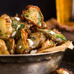Roasted Jerusalem artichokes - sprinkled with feta cheese and drizzled with garlic dill butter - they are simply finger-licking good! | www.viktoriastable.com