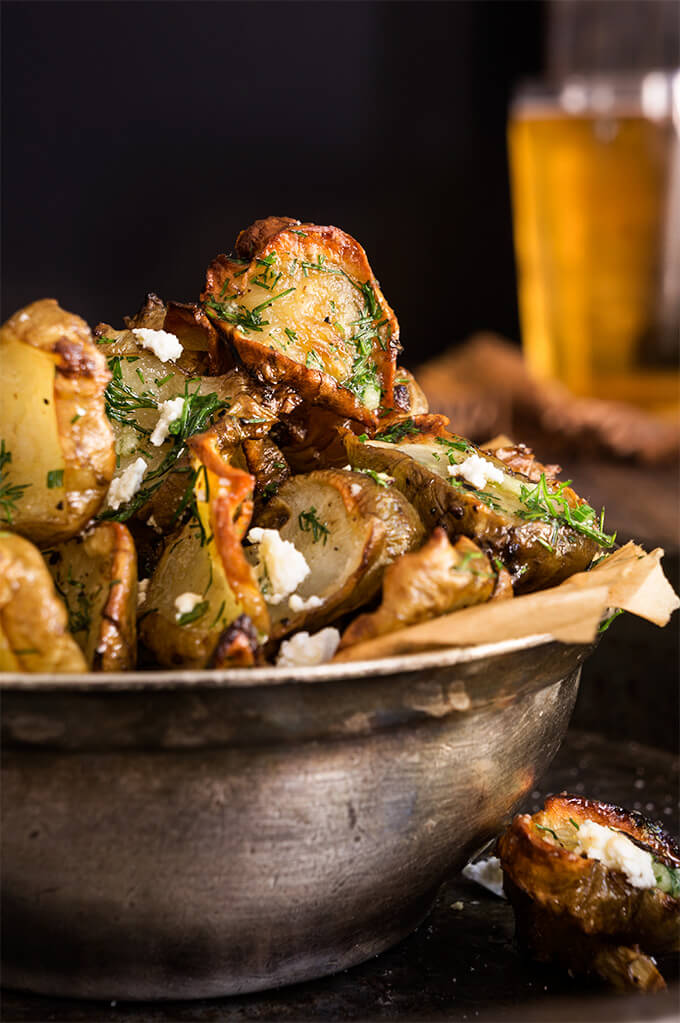 Roasted Jerusalem artichokes - sprinkled with feta cheese and drizzled with garlic dill butter - they are simply finger-licking good! | www.viktoriastable.com