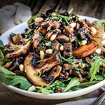 Sauteed oyster and brown mushrooms, black lentils, and caramelized onions are the basis for this lovely fall salad, with pine nuts and capers adding a great flavor boost.