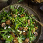 Mushroom and arugula salad with goat cheese, toasted walnuts, and celery - tossed in shallot mustard and truffle oil vinaigrette, this salad is bursting with earthy, fall flavors. | www.viktoriastable.com