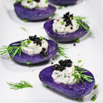 Purple potato bites with horseradish creme fraiche and caviar - bold colors and big flavors packed into a small, delicious morsel - the perfect starter for your holiday dinner or a cocktail party. | www.viktoriastable.com