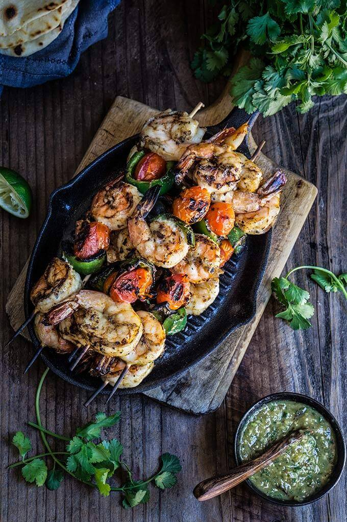 Grilled shrimp tacos with tomatillo salsa and homemade tortillas - bursting with flavor, juicy shrimp, grilled ppoblano peppers and tomatoes, topped with freshly made salsa verde, and served over soft homemade flour tortillas. | www.viktoriastable.com