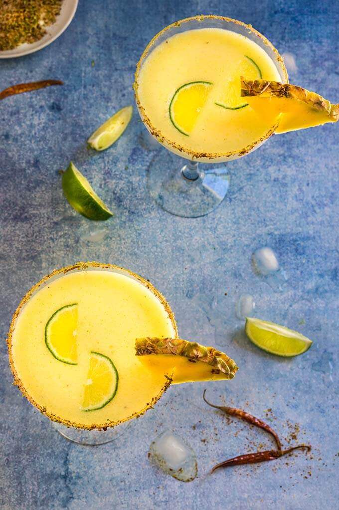 Spicy pineapple margarita - icy-cold, with a spicy kick, fruity and refreshing, served with fragrant chili lime salt, this drink will give you just the right amount of heat and freshness. | www.viktoriastable.com