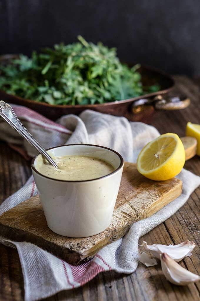Creamy low fat Caesar salad dressing - healthy Caesar dressing which is packed with protein, low in fat, yet creamy and robust in flavor. | www.viktoriastable.com
