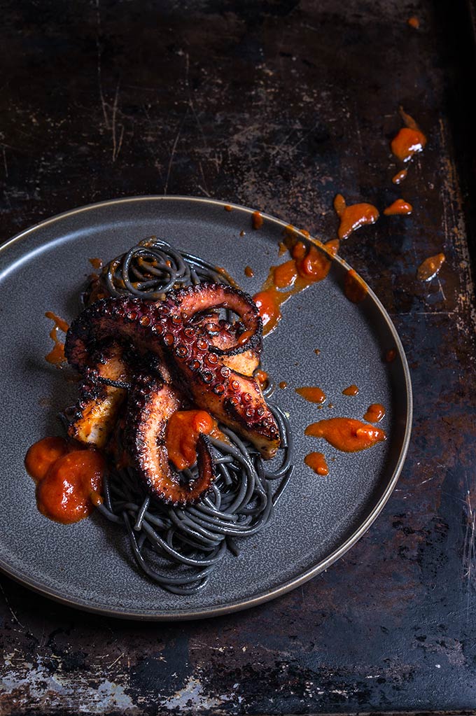 Grilled octopus over squid ink pasta and tomato garlic sauce - Viktoria's  Table